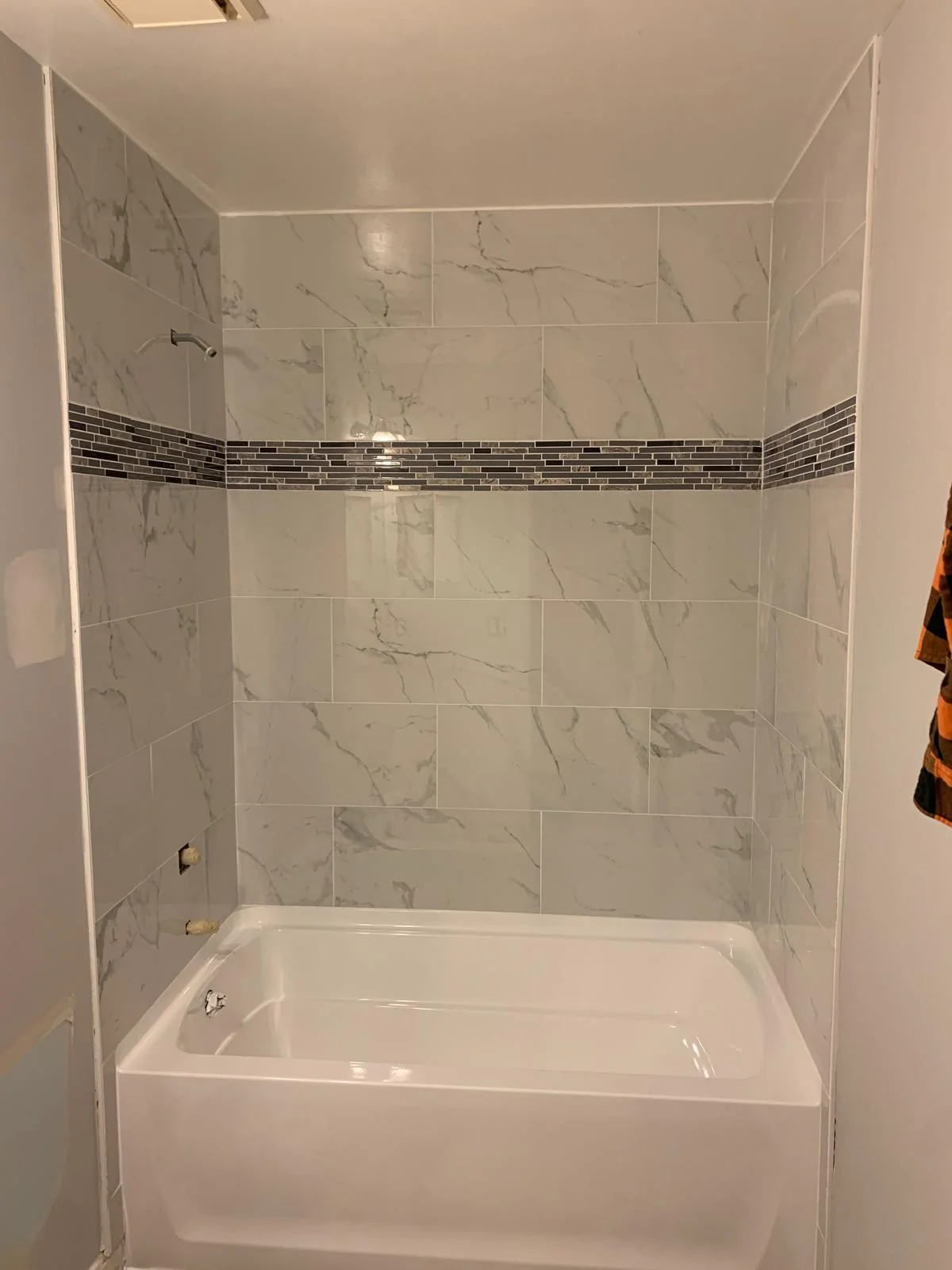 Alternate view of marble-look tiled bathtub surround