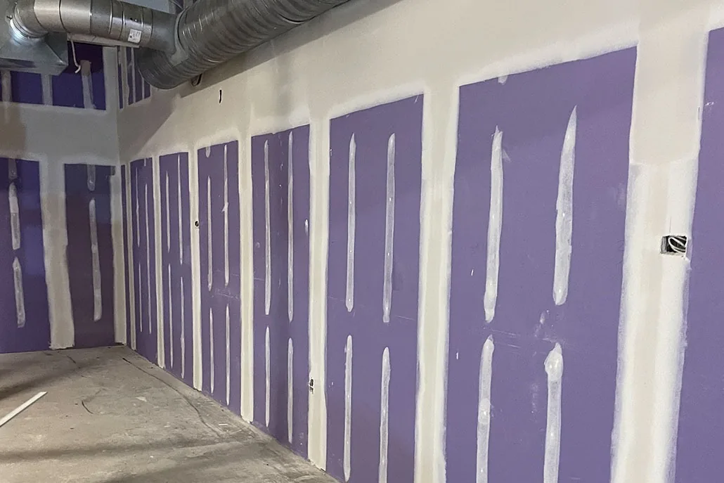 Commercial wall with taped drywall seams during finishing