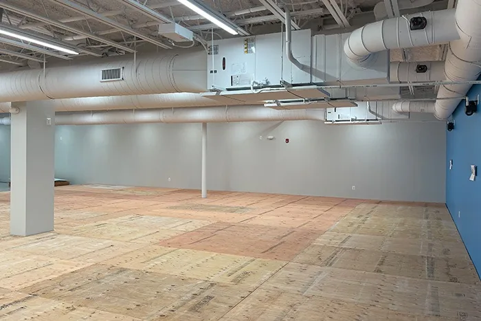 Commercial open space showing coordinated wall, ceiling and floor work