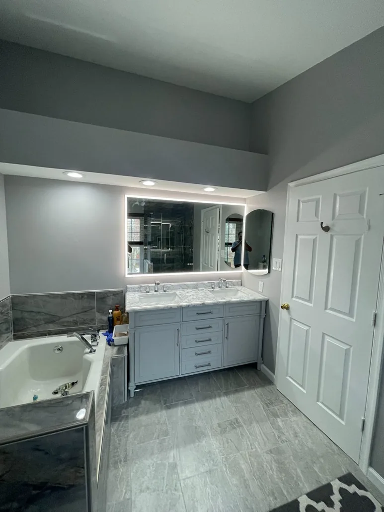 Second view of a compact kitchen with gray cabinetry and updated lighting