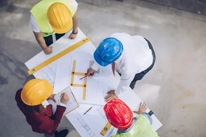 Construction team reviewing drawings and project details