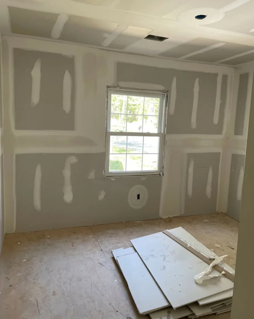 Bedroom during drywall installation and seam finishing