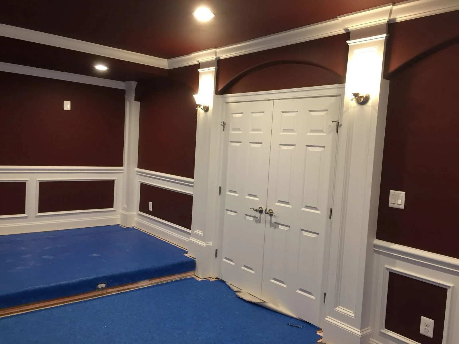 Interior room with burgundy walls, white trim and decorative doorway details