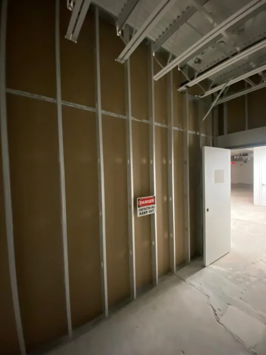 Commercial corridor with metal framing and exposed ceiling systems