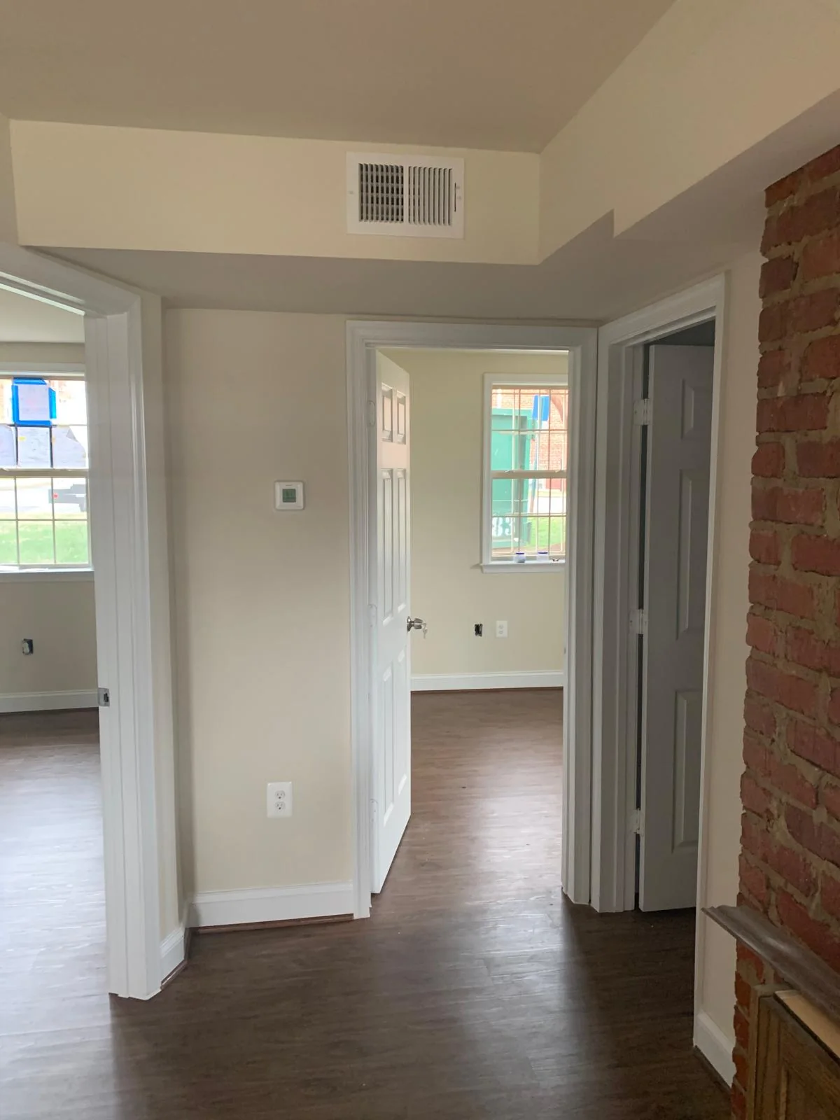 Residential interior entry and hallway with exposed brick detail