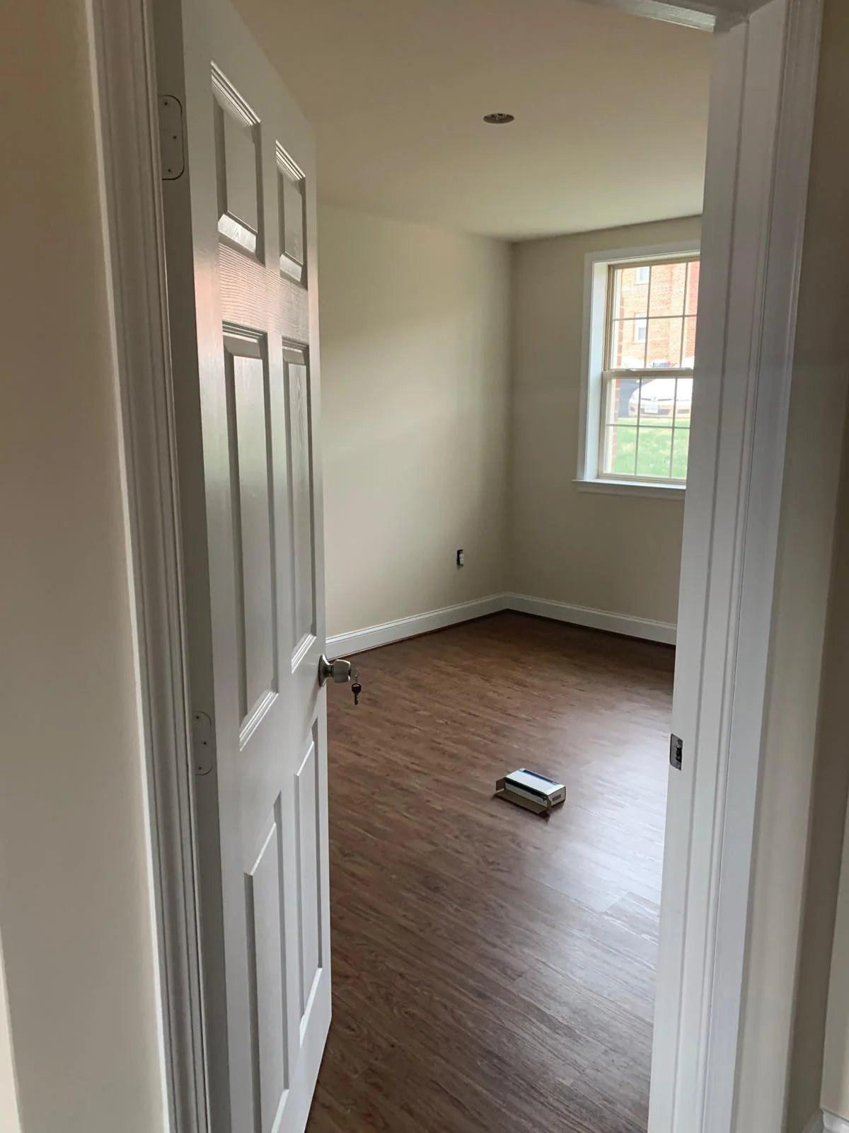 Residential room with wood-look flooring and updated wall finishes