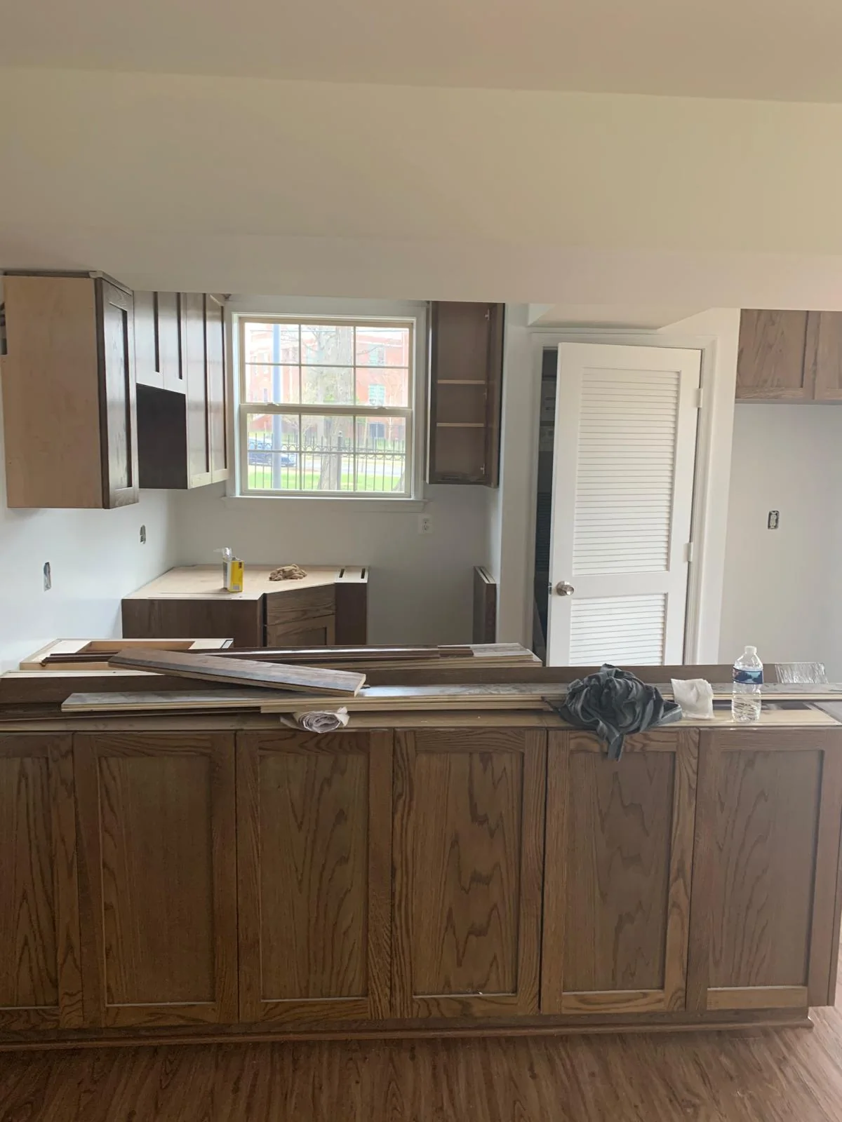 Kitchen with wood cabinetry and island before or during renovation work
